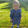 baby, child, toddler, portrait, outdoor, lawn, grass, sunlight, lens_flare, dress, checkered_pattern, blue_and_white, shoes, socks, standing, face, eyes, fashion, backyard, smiling