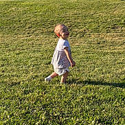 Athena joined the competition — help win amazing prizes! toddler, child, baby, walking, smiling, outdoors, grass, lawn, sunlight, portrait, profile, playful, toddler_clothing, shirt, shorts, socks, field, nature, daylight, happy