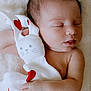 newborn, baby, sleeping, plush_toy, bunny, hearts, soft_texture, blanket, infant, peaceful, cute, hand, face, portrait, closeup, resting, skin, child, toddler, adorable