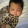 baby, sleeping, infant, leopard_print, onesie, blanket, closeup, face, hand, soft, cute, peaceful, child, portrait, indoors, resting, newborn, cozy, skin, hair