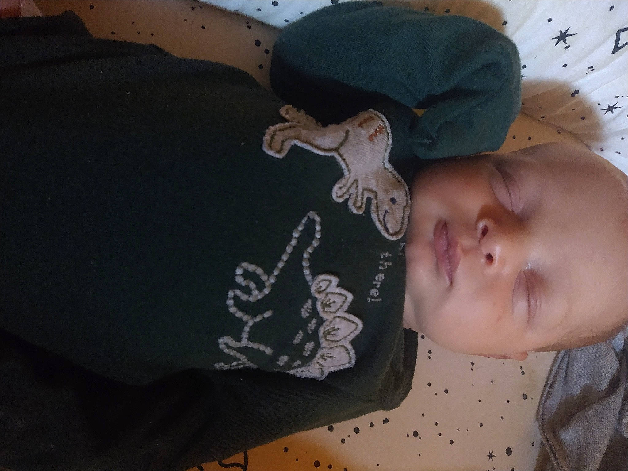 Marcellus is registered to the contest to win money with this photo: baby, baby_products, baby_toddler_clothing, brown, cheek, child, comfort, elbow, linens, pattern, person, sleeve, t_shirt, toddler