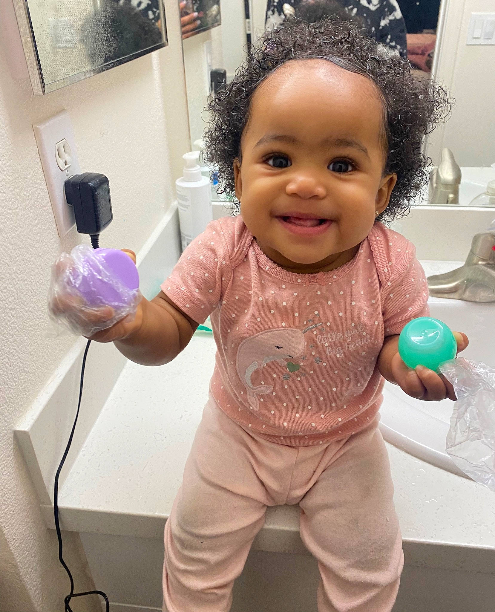 Aaliyah is registered to the contest to win money with this photo: arm, baby, cheek, eye, finger, gesture, hand, happy, head, iris, joint, joy, person, picture_frame, pink, purple, room, skin, sleeve, smile