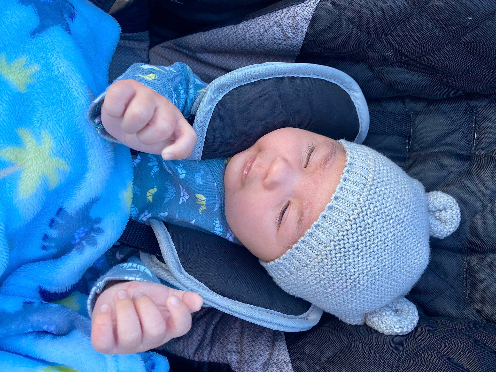 Alex is registered to the contest to win money with this photo: baby, baby_products, baby_toddler_clothing, blue, comfort, electric_blue, face, finger, gesture, grass, hand, head, headwear, human_body, nail, person, plant, sleeve, smile, thumb