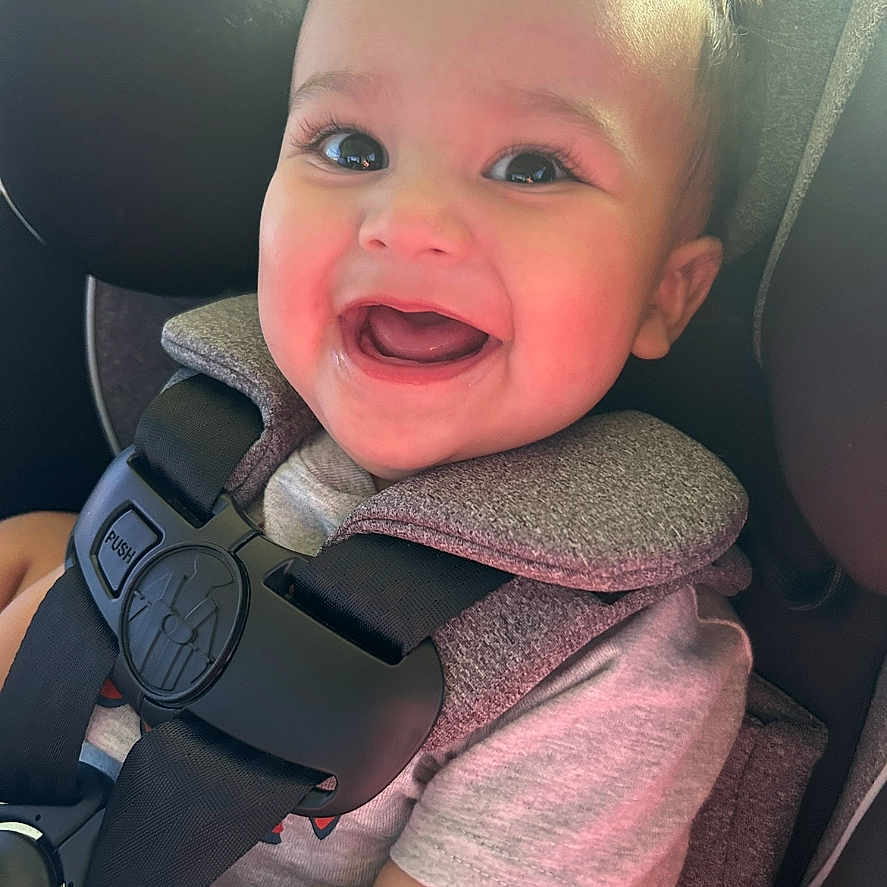 David is registered to the contest to win money with this photo: accessories, baby, babylaughing, belt, bodypart, car, car_interior, cushion, face, finger, hand, happy, head, homedecor, person, photography, portrait, smile, transportation, vehicle