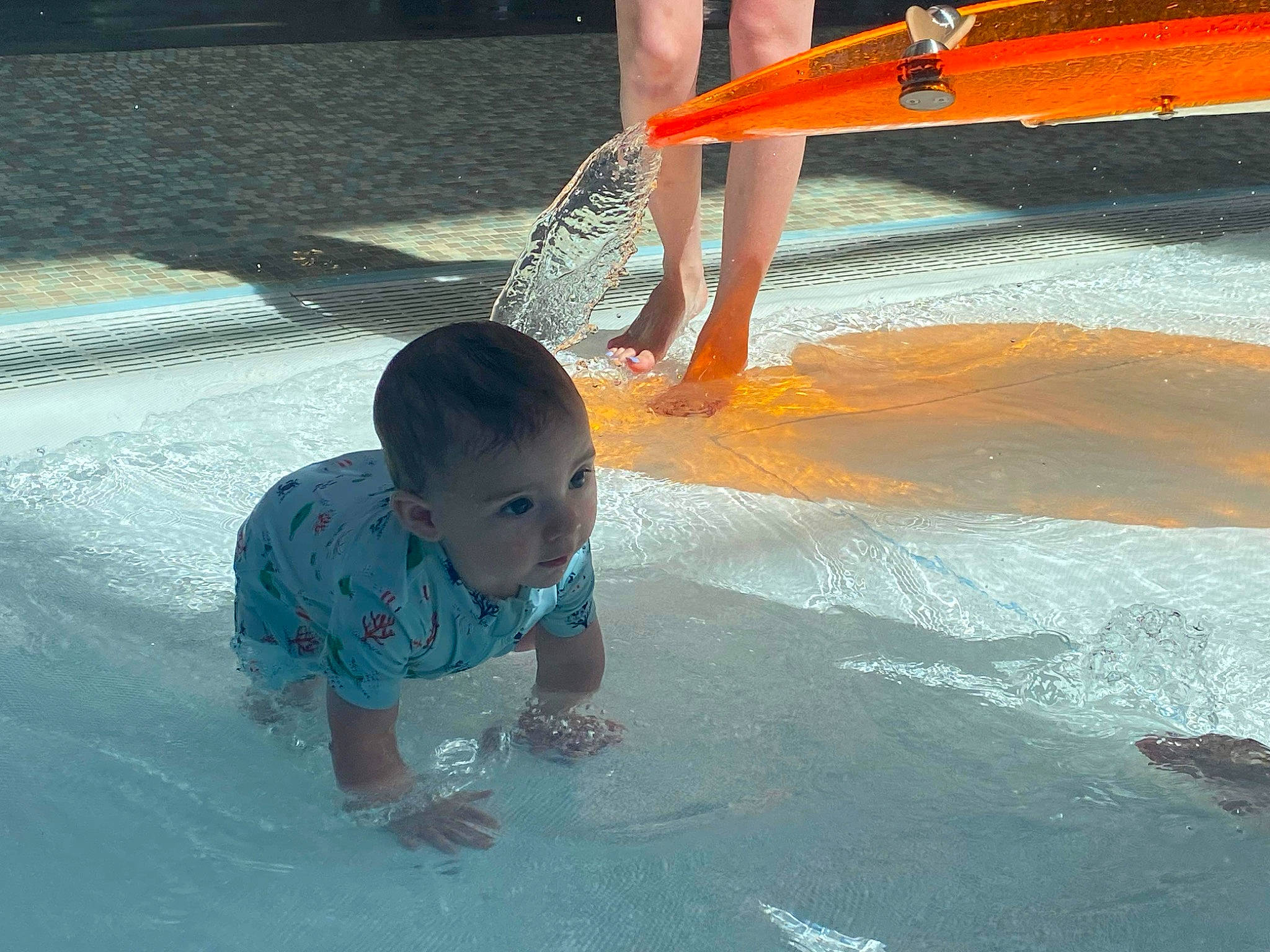 Brantley is registered to the contest to win money with this photo: asphalt, baby, barefoot, boats_and_boating_equipment_and_supplies, child, concrete, flooring, foot, fun, human_leg, leg, leisure, light, person, play, recreation, toddler, vacation, water, watercraft