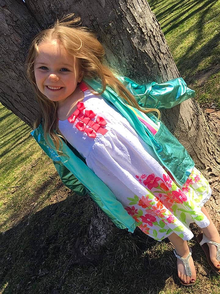 Karly is registered to the contest to win money with this photo: blond, child, dress, fashion_accessory, grass, green, hair, hair_coloring, hairstyle, happy, joy, long_hair, people_in_nature, person, pink, plant, smile, spring, summer, tree