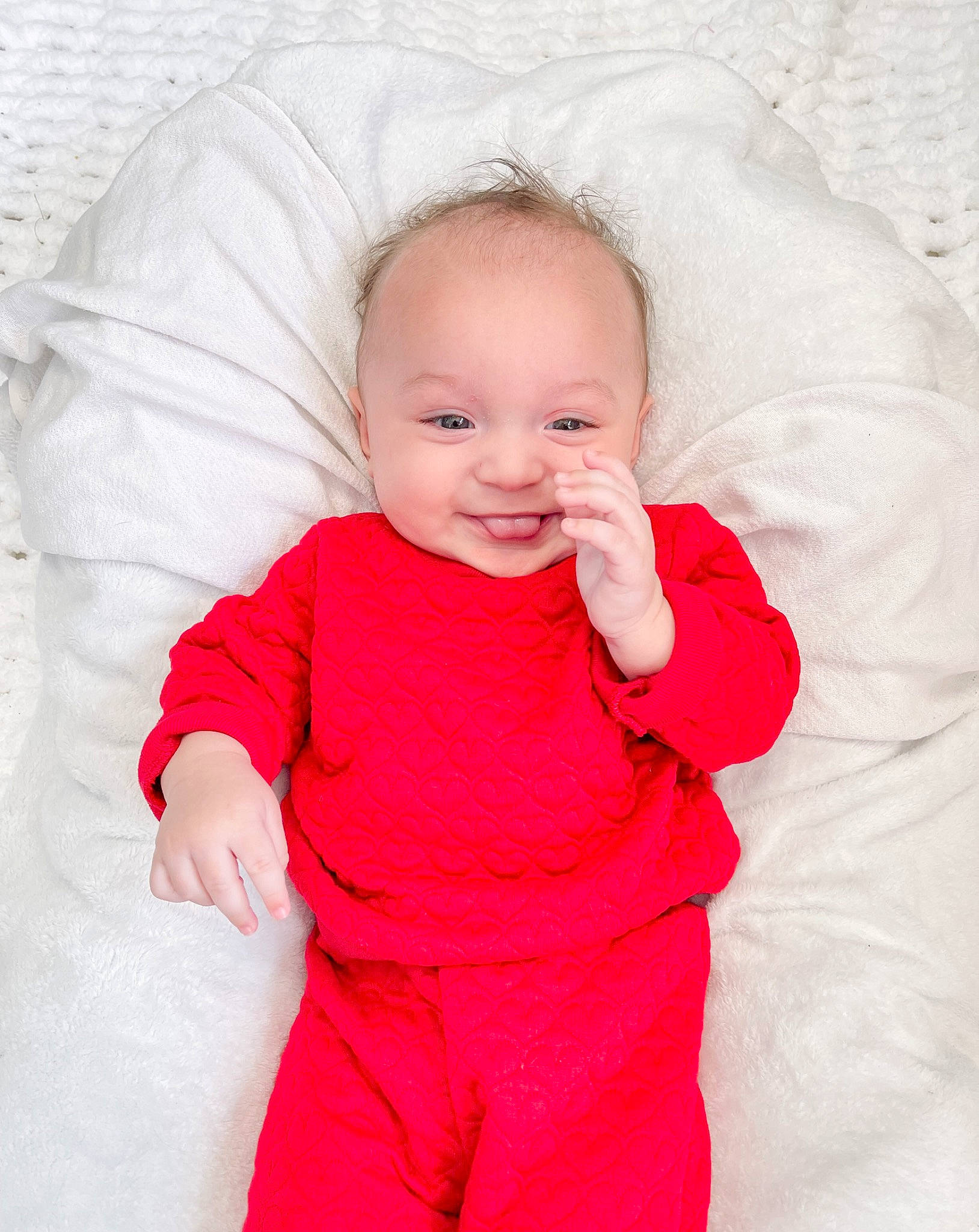 Brooks is registered to the contest to win money with this photo: baby, baby_toddler_clothing, cheek, chin, comfort, eye, face, gesture, happy, head, human_body, iris, lip, neck, nose, person, pink, sleeve, smile, thumb