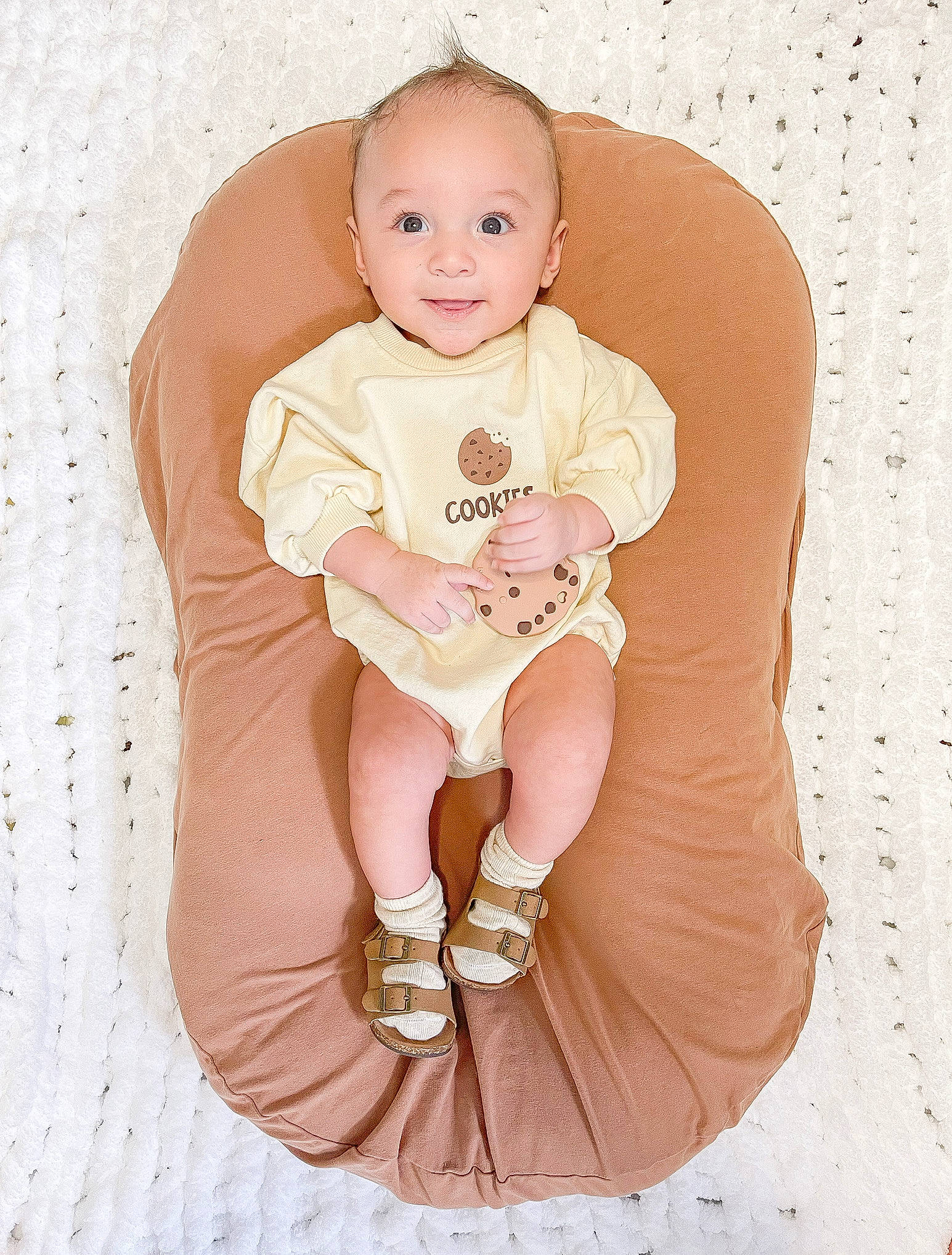 Brooks joined the competition — help win amazing prizes! baby, baby_products, baby_toddler_clothing, child, comfort, face, happy, head, human_body, human_leg, knee, leg, person, pink, sitting, sleeve, smile, sock, stomach, thigh