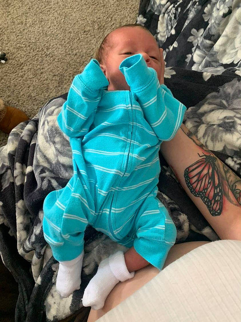 Miki is registered to the contest to win money with this photo: aqua, azure, baby, baby_products, baby_toddler_clothing, comfort, elbow, electric_blue, human_leg, knee, linens, military_camouflage, pattern, person, personal_protective_equipment, sitting, sleeve, temporary_tattoo, textile, thigh