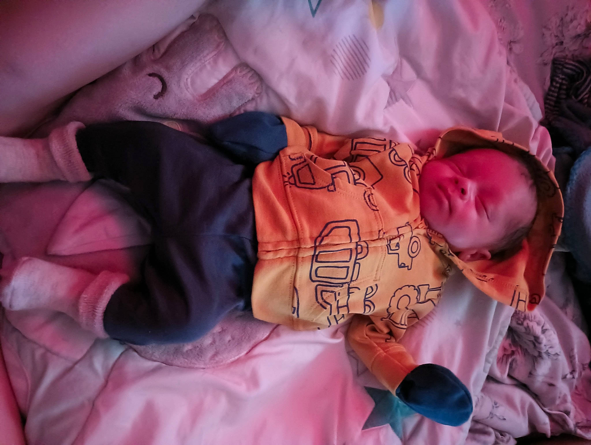 Miki is registered to the contest to win money with this photo: arm, baby, baby_toddler_clothing, cheek, child, comfort, eye, facial_expression, finger, hand, human_body, linens, magenta, mammal, mouth, person, pink, purple, skin, toddler