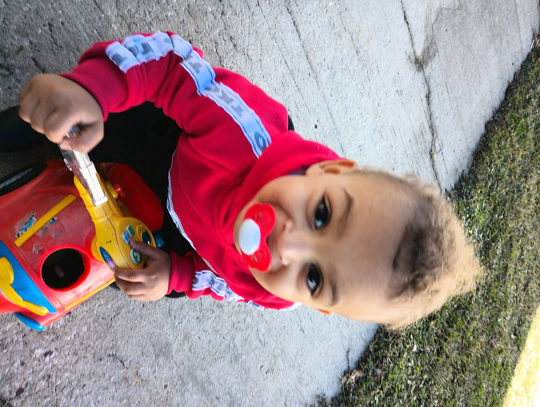 Niko is registered to the contest to win money with this photo: baby, child, fun, grass, happy, hat, headgear, landscape, leisure, musical_instrument, nose, person, plant, play, recreation, smile, toddler, toy, tree, vacation