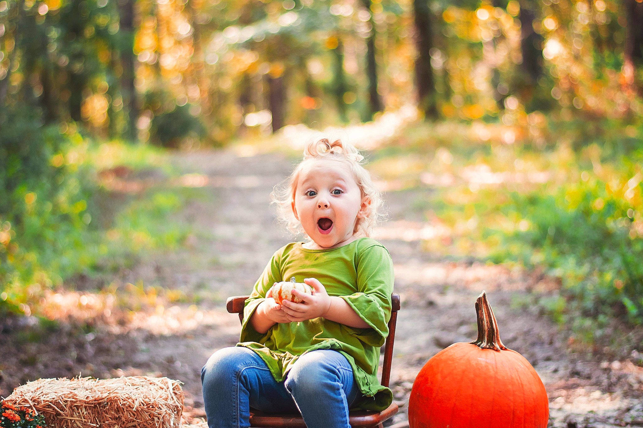 Ashlyn is registered to the contest to win money with this photo: autumn, calabaza, child, family, happy, leaf, people_in_nature, person, photograph, photography, plant, playing_with_kids, portrait_photography, pumpkin, sitting, surprise, toddler, tree