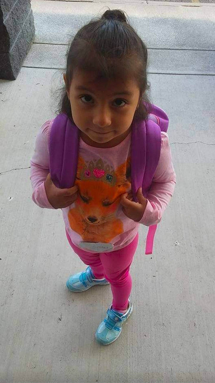 Alicia is registered to the contest to win money with this photo: arm, baby_toddler_clothing, cheek, clothing, face, footwear, hair, hand, happy, head, lip, mouth, nose, person, pink, purple, skin, sleeve, smile, toddler