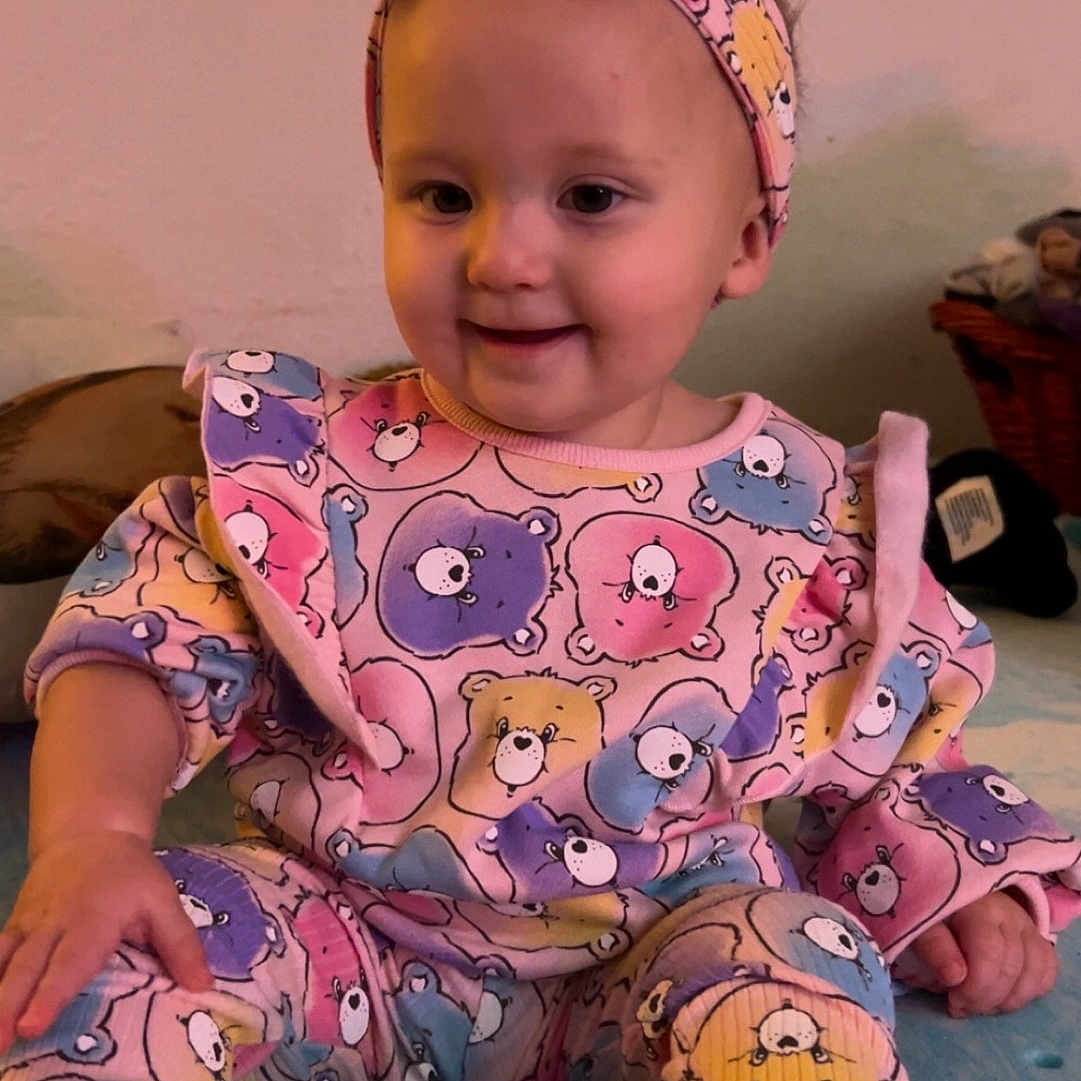 Danielle joined the competition — help win amazing prizes! accessories, baby, bodypart, bonnet, clothing, costume, dress, face, finger, hand, happy, hat, head, headband, pajamas, person, photography, portrait, sitting, smile