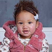 Veriya joined the competition — help win amazing prizes! child, toddler, curly_hair, bow, pink_vest, floral_shirt, face, portrait, indoor, cute, smile, young_child, cozy_clothing, curious, baby, person, fashion, hairstyle, expression, studio_photo