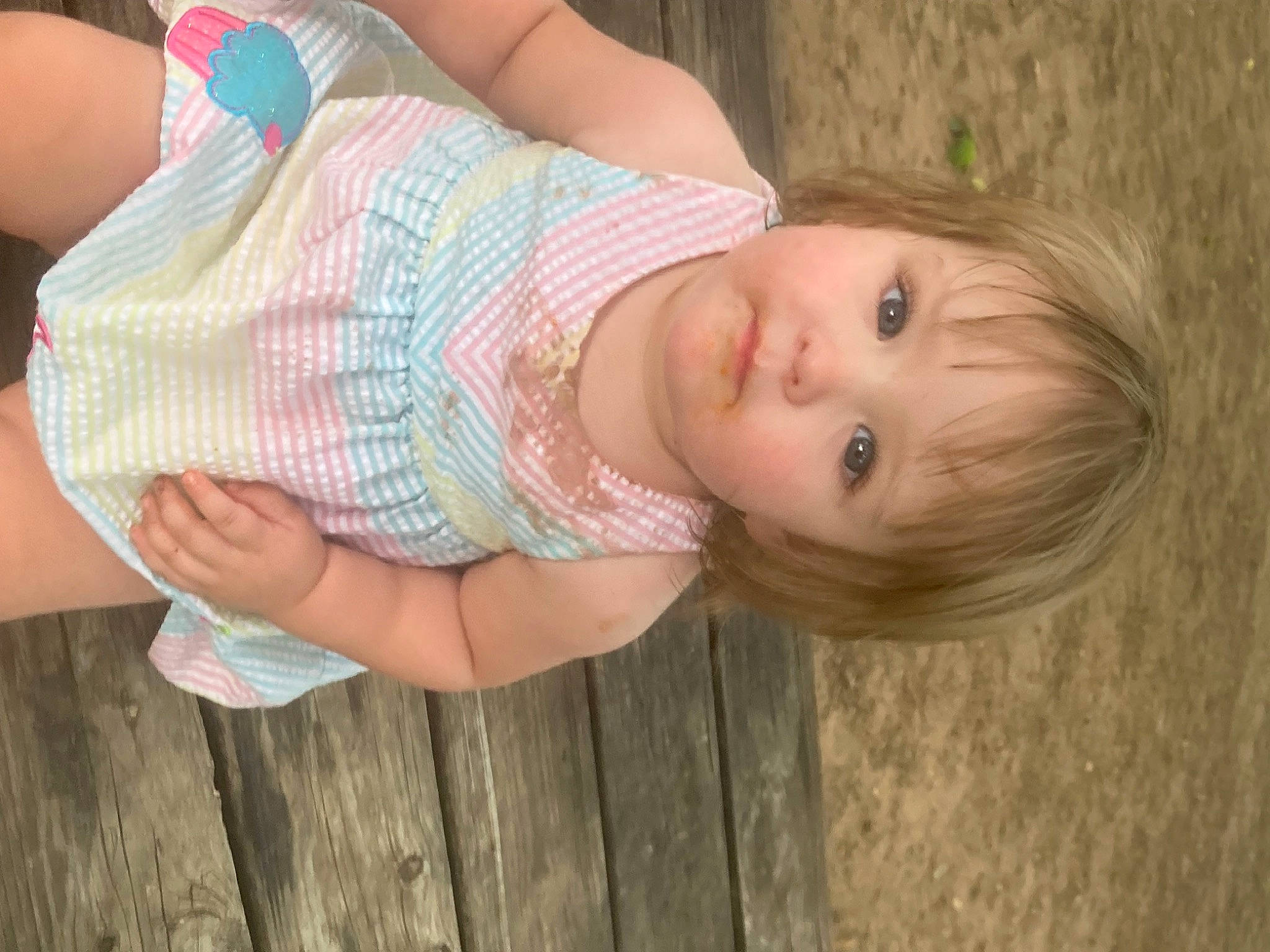 Ruby is registered to the contest to win money with this photo: baby, baby_toddler_clothing, cheek, child, elbow, gesture, grass, happy, human_body, human_leg, lip, nose, pattern, person, plant, skin, smile, toddler, tree, trunk