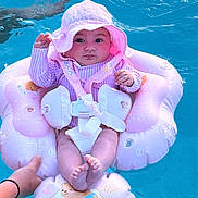 Felicity joined the competition — help win amazing prizes! baby, child, cute, face, feet, hands, infant, inflatable_float, outdoor, parental_supervision, photograph, pink, portrait, recreation, sitting, striped_clothing, summer, sun_hat, swimming_pool, water