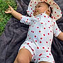 baby, child, grass, blanket, outdoor, hat, polka_dot, white_clothing, red, skin, legs, arm, nature, infant, cute, relaxed, exploring, summer, sunlight, lying_down