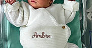 Ambre participe au concours pour gagner de l'argent avec cette photo : baby, newborn, infant, knitted_clothing, white_outfit, headband, bow, crib, hospital, blanket, lying_down, cute, small_hands, tiny_feet, peaceful, curious, portrait, indoors, child, person