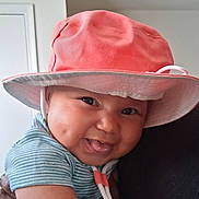Royal joined the competition — help win amazing prizes! baby, child, smiling, tongue_out, hat, pink_hat, striped_shirt, cheeks, face, person, indoor, happy, cute, young_child, headwear, playful, holding, close_up, skin, infant