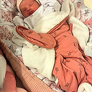 Mylénah participe au concours pour gagner de l'argent avec cette photo : newborn, baby, sleeping, blanket, hat, baby_nest, soft_texture, cozy, pink, white, floral_pattern, swaddle, infant, resting, cute, warm, comfort, child, bed, portrait