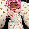 Kyomi is registered to the contest to win money with this photo: baby, infant, sleeping, pacifier, pink_bonnet, mittens, onesie, heart_pattern, pillow, butterfly_pattern, cute, child, resting, adorable, soft_lighting, indoor, portrait, newborn, sleepwear, peaceful