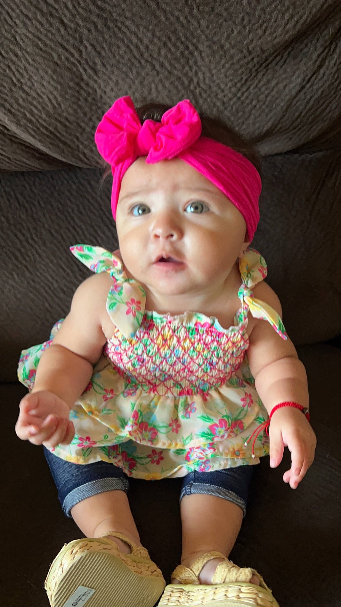 Ella is registered to the contest to win money with this photo: arm, baby, baby_toddler_clothing, cap, cheek, dress, eye, face, hand, headwear, human_body, lip, magenta, neck, outerwear, person, pink, skin, sleeve, textile