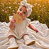 baby, baby_clothes, blanket, bow, child, cute, field, grass, headband, infant, nature, outdoor, portrait, shoes, sitting, smiling, socks, sunset, wildflowers, wooden_sign