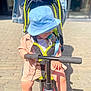 Erwann participe au concours pour gagner de l'argent avec cette photo : baby, blue_hat, child, cute, denim_jacket, outdoor, pacifier, pavement, play, safety_harness, scooter, shoes, sidewalk, stroller, summer_clothing, sunlight, toddler, toy, urban, white_shoes