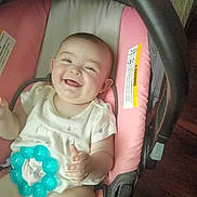 Hope joined the competition — help win amazing prizes! baby, smiling, car_seat, teething_toy, pink, white_clothing, infant, happy, cute, child, indoors, person, seat, toy, young_child, face, sitting, joyful, childhood, playful