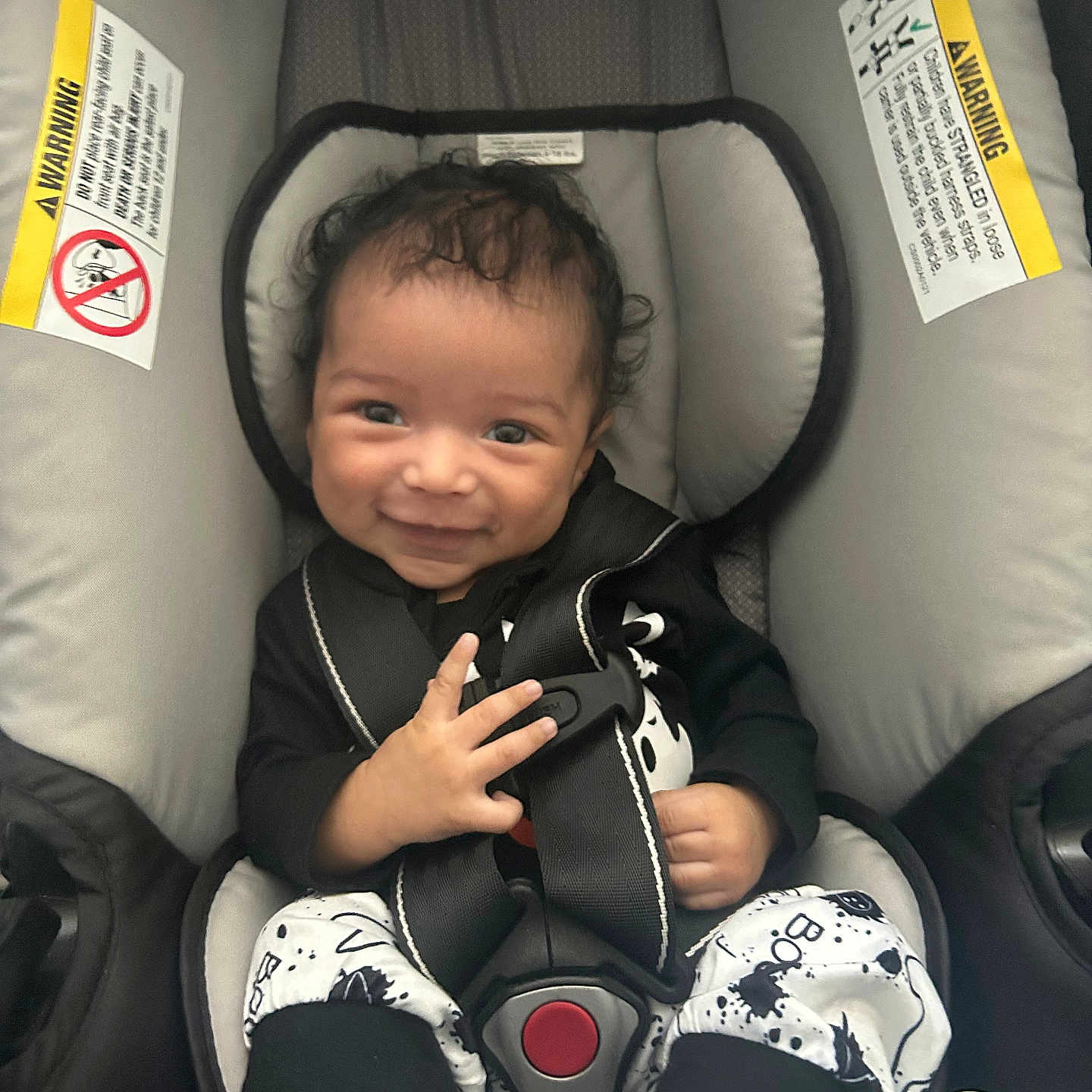 Tyran is registered to the contest to win money with this photo: baby, bodypart, clothing, coat, cushion, face, finger, furniture, hand, happy, head, homedecor, jacket, person, photography, portrait, sitting, smile, transportation, vehicle
