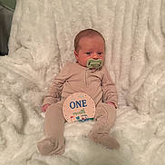 Charles joined the competition — help win amazing prizes! baby, blanket, child, cozy, cute, face, indoor, infant, milestone_card, newborn, one_month, pacifier, pajamas, person, portrait, resting, sitting, smiling, soft_texture, young
