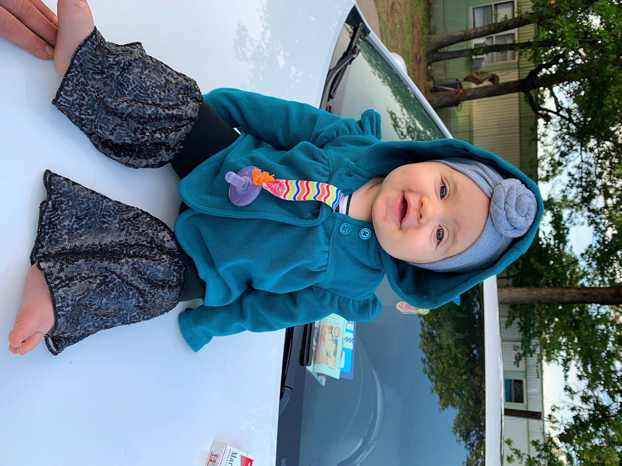 Delaney is registered to the contest to win money with this photo: blue, child, fun, headwear, person, smile, toddler, tree, vacation