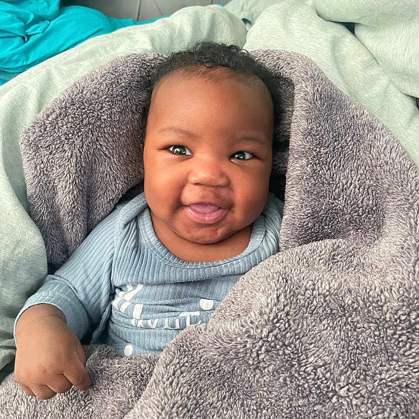 Zaid joined the competition — help win amazing prizes! baby, babylaughing, blanket, face, happy, head, person, photography, portrait, quilt, smile