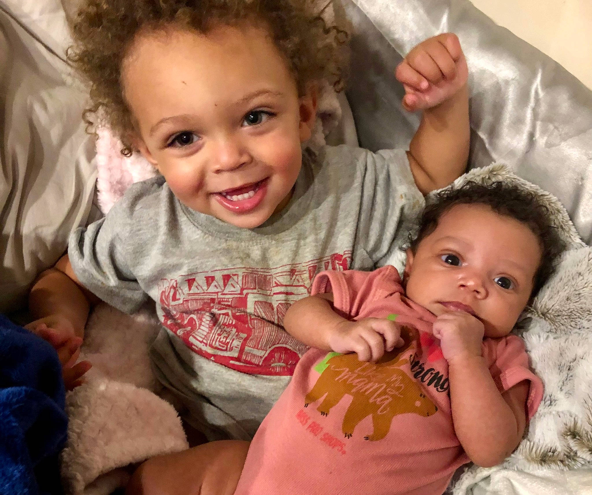 Bralyn is registered to the contest to win money with this photo: arm, baby_toddler_clothing, cheek, chin, comfort, eye, face, finger, gesture, happy, human, iris, joy, mouth, nose, organ, person, sharing, skin, sleeve