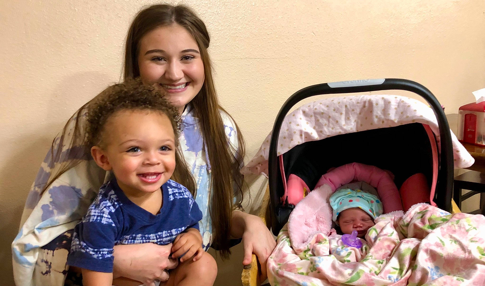 Kyrie is registered to the contest to win money with this photo: baby, baby_toddler_clothing, cheek, child, comfort, event, eye, face, facial_expression, family_taking_photos_together, fun, happy, head, headwear, infant_bed, iris, joy, person, sharing, sitting