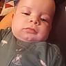 baby, baby_boy, child, chubby, closeup, cute, face, green_clothing, head, indoors, infant, onesie, pattern, person, pillow, portrait, relaxed, skin, sleepy, young_child