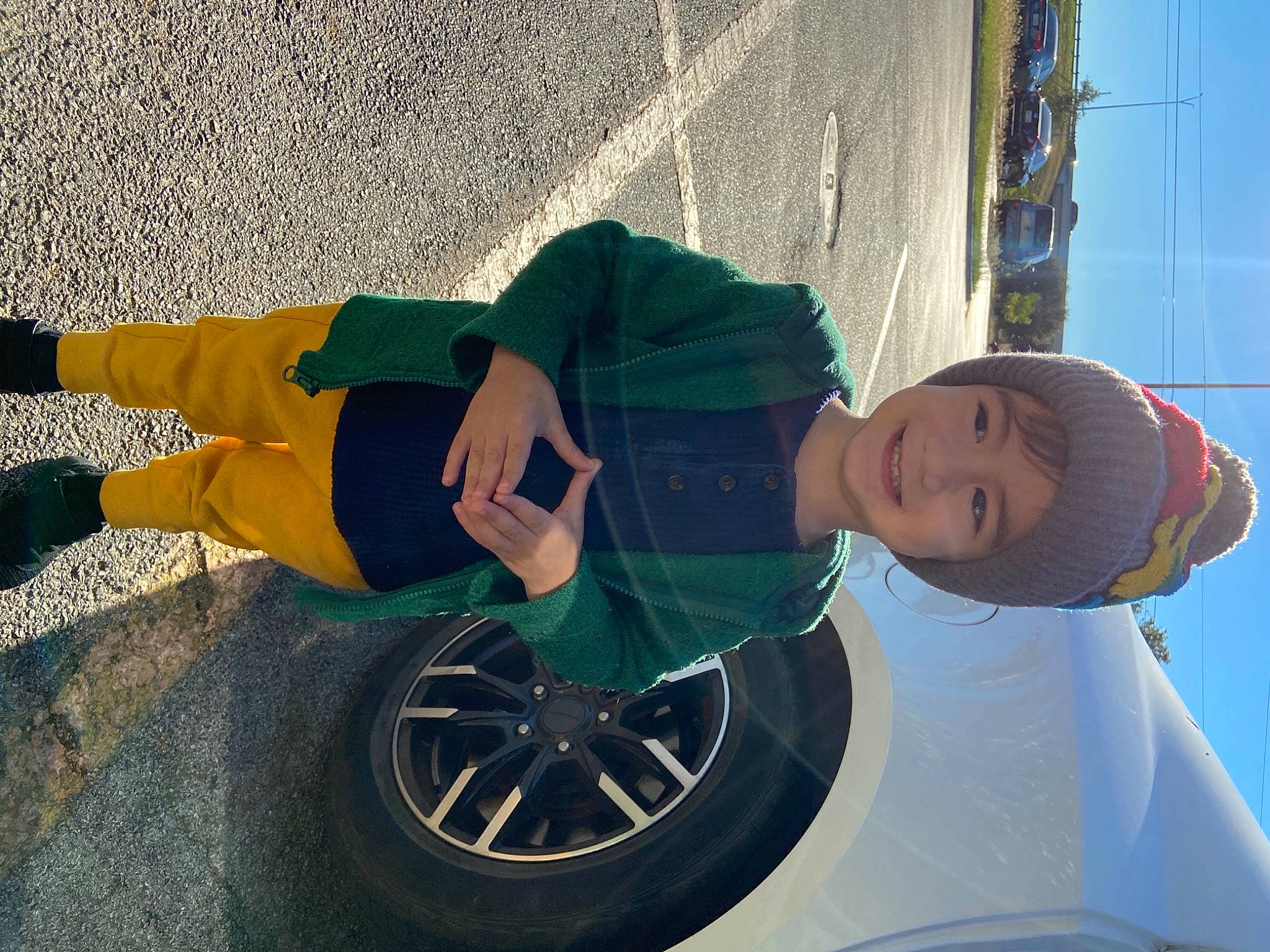 Dale is registered to the contest to win money with this photo: alloy_wheel, automotive_tire, automotive_wheel_system, costume, green, headwear, hubcap, joy, person, rim, spoke, synthetic_rubber, tire_care, tread