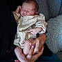 Lola is registered to the contest to win money with this photo: newborn, baby, sleeping, infant, hands, adult, couch, blanket, clothing, peaceful, resting, indoor, portrait, cozy, soft, skin, person, comfort, relaxation, seated