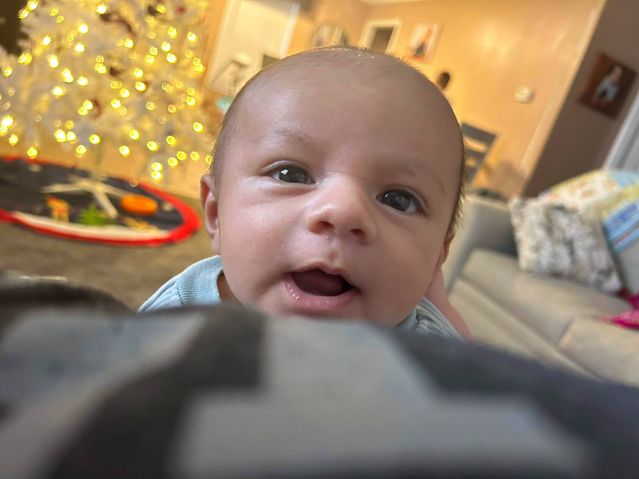 Chase joined the competition — help win amazing prizes! baby, cheek, child, christmas_ornament, close_up, comfort, ear, event, fun, happy, holiday, laugh, mouth, nose, ornament, person, room, sitting, smile, toddler