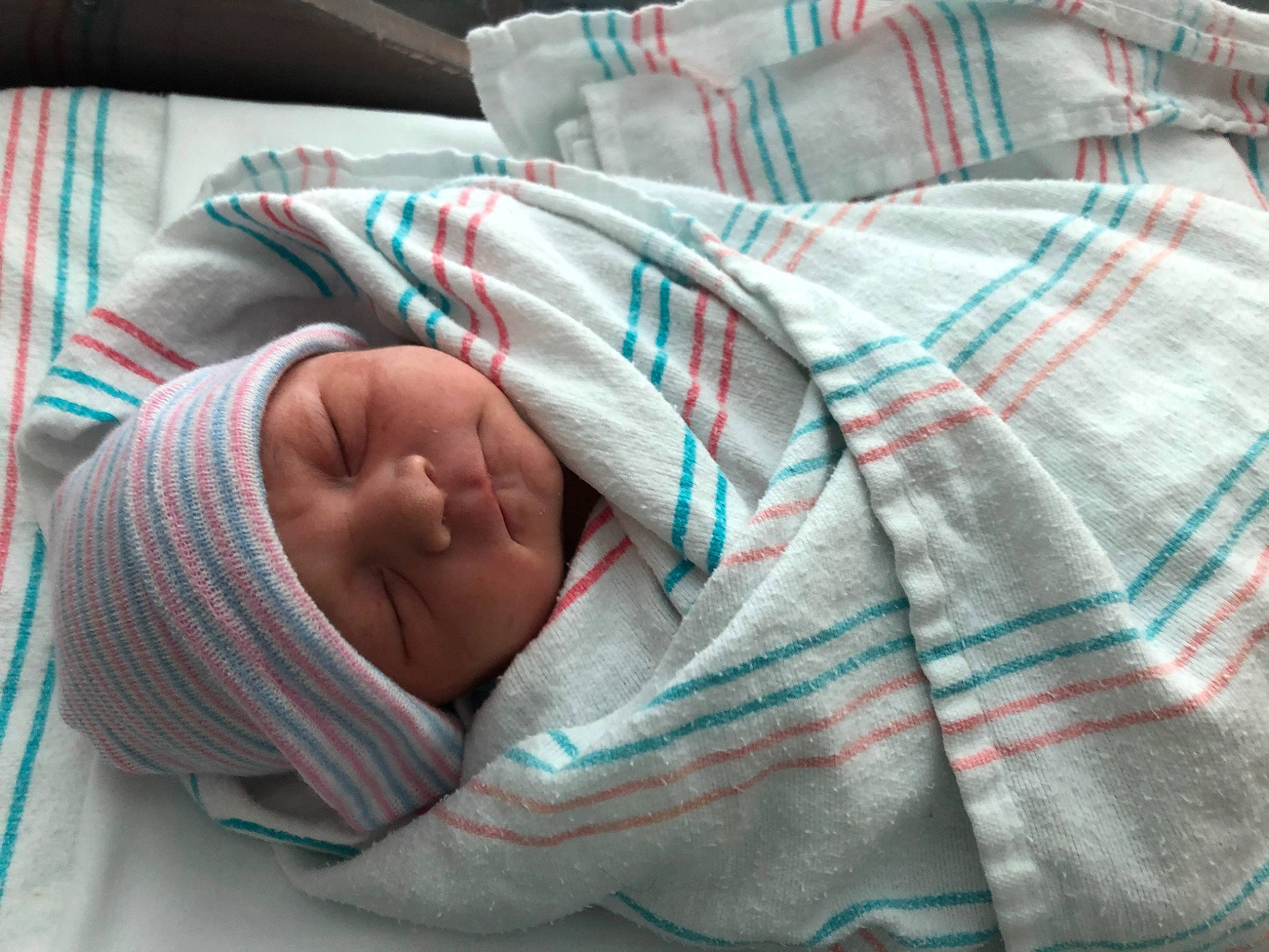 Lydia is registered to the contest to win money with this photo: baby, bedtime, blanket, child, comfort, headwear, linens, nap, person, sleep, textile, wool