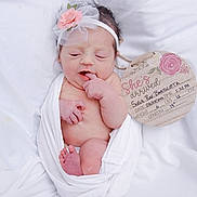 Sofia joined the competition — help win amazing prizes! newborn, baby, infant, headband, flower, white_cloth, wrapped, sleeping, plaque, birth_announcement, soft_blanket, peaceful, cute, small, pink_flower, skin, human, portrait, lying_down, indoors