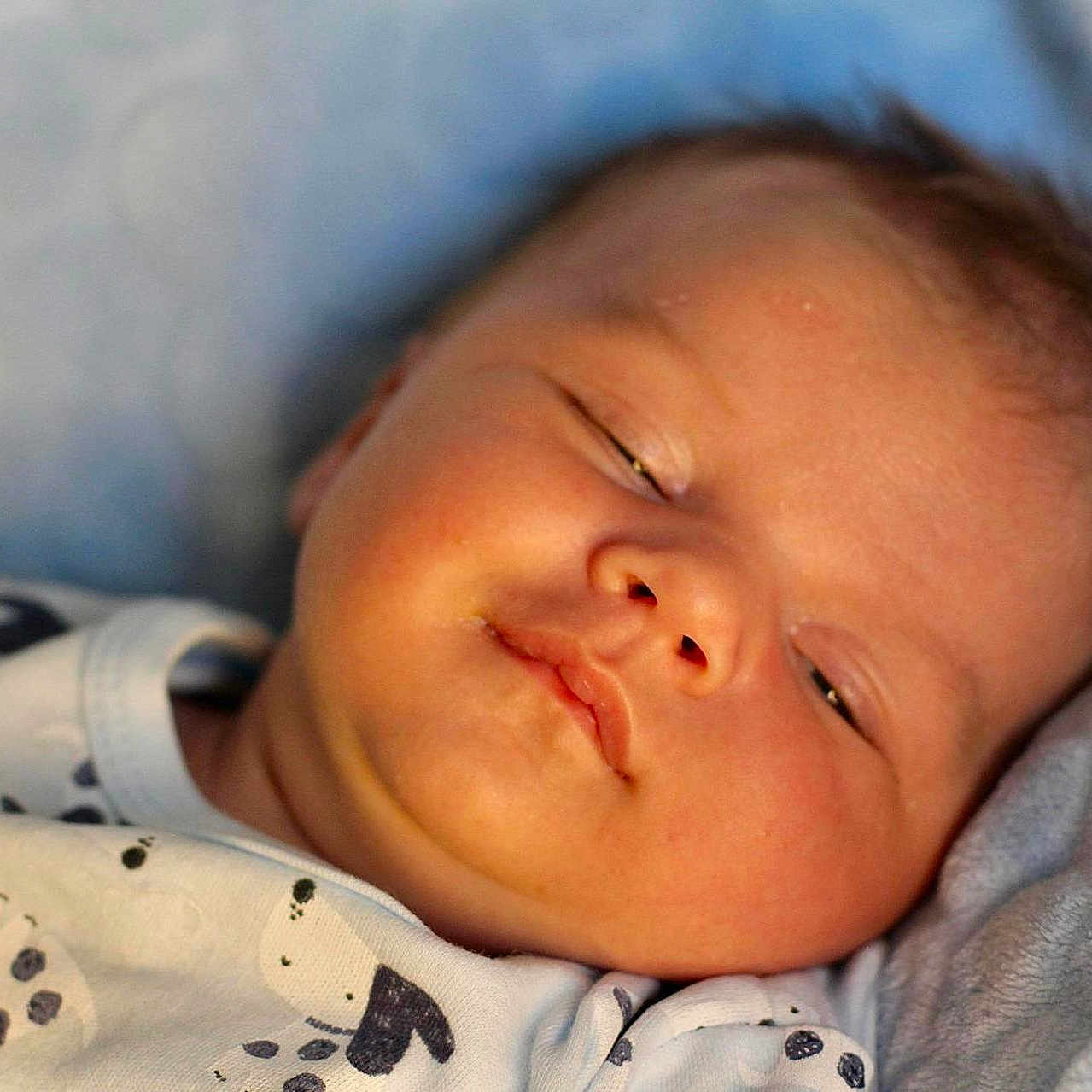 Alfie is registered to the contest to win money with this photo: baby, bed, blanket, face, furniture, happy, head, newborn, person, photography, portrait, quilt, sleeping, smile