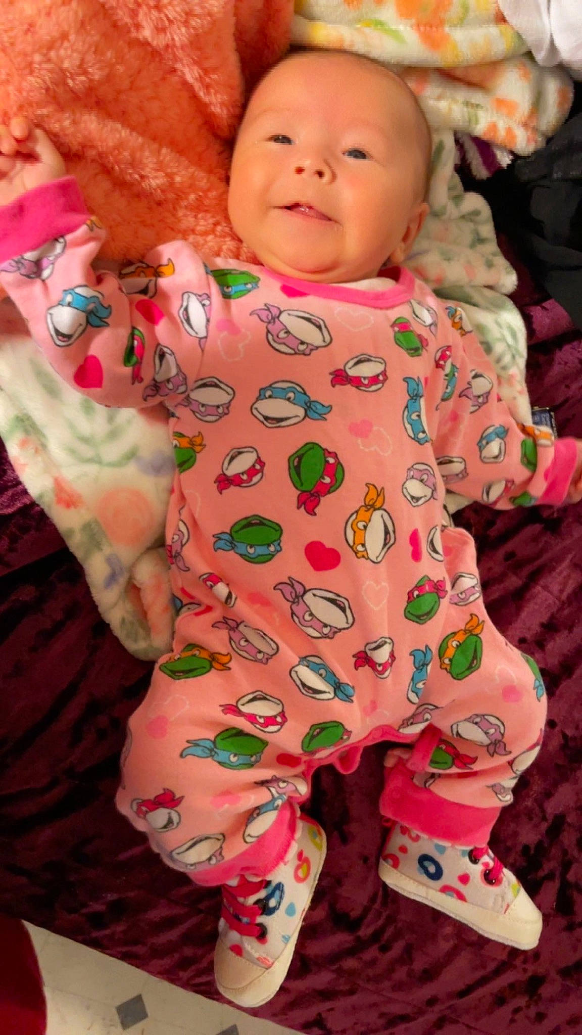 Melina joined the competition — help win amazing prizes! arm, baby, baby_toddler_clothing, cheek, collar, face, facial_expression, green, happy, head, human_body, joy, neck, nose, orange, outerwear, person, pink, skin, sleeve