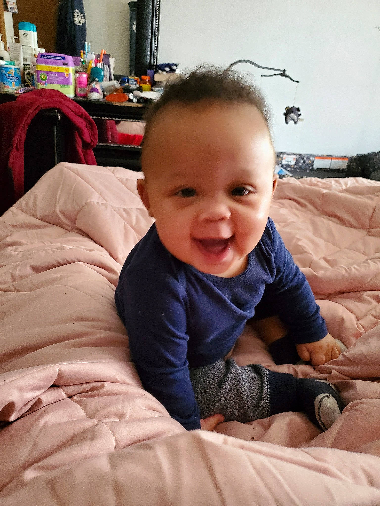 Liam is registered to the contest to win money with this photo: baby, cheek, child, comfort, eye, face, finger, furniture, person, room, sitting, skin, smile, toddler