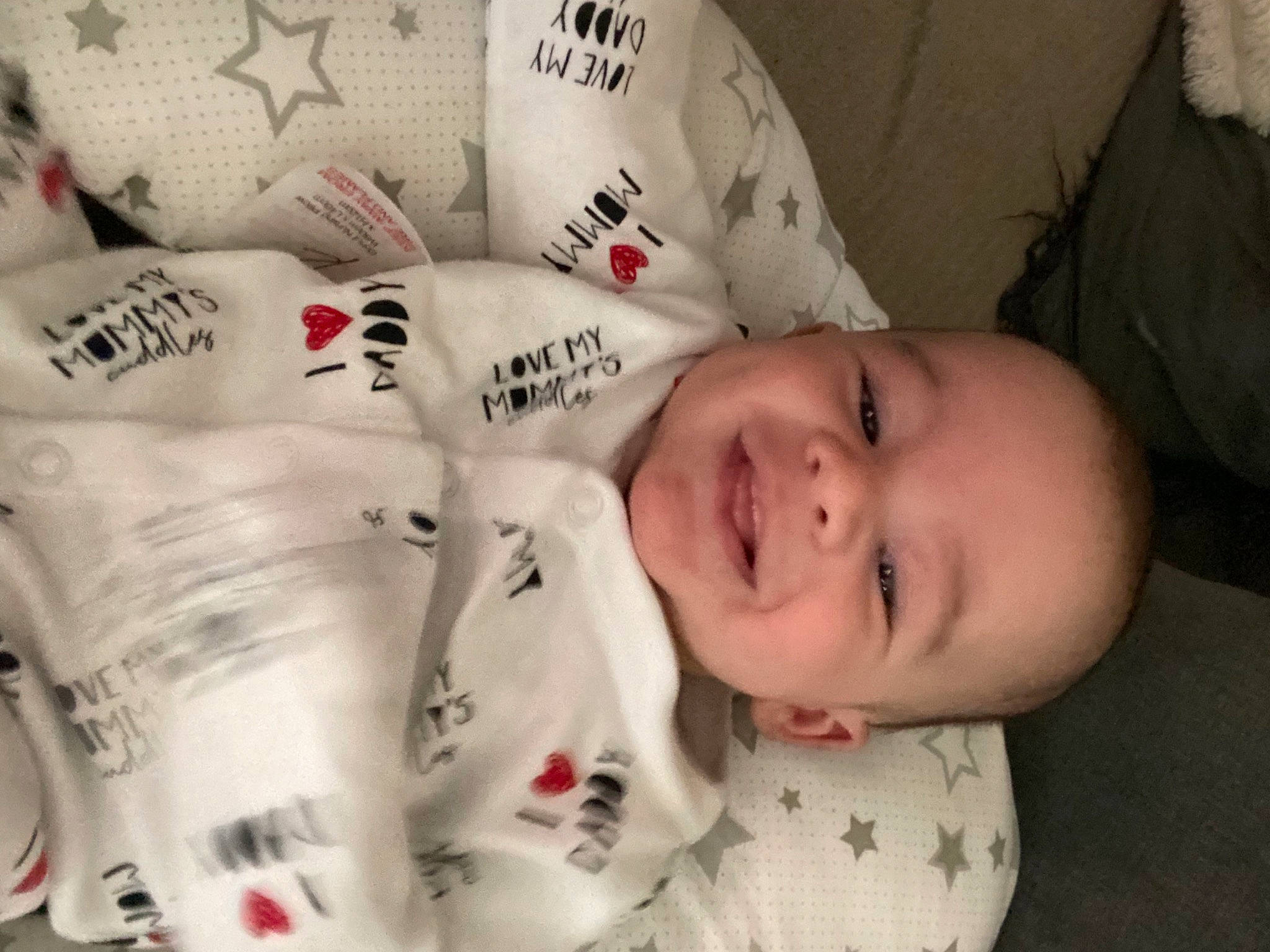 Tyler is registered to the contest to win money with this photo: baby, baby_laughing, baby_toddler_clothing, carmine, cheek, child, comfort, drinkware, face, facial_expression, font, happy, head, linens, mammal, pattern, person, skin, sleeve, smile