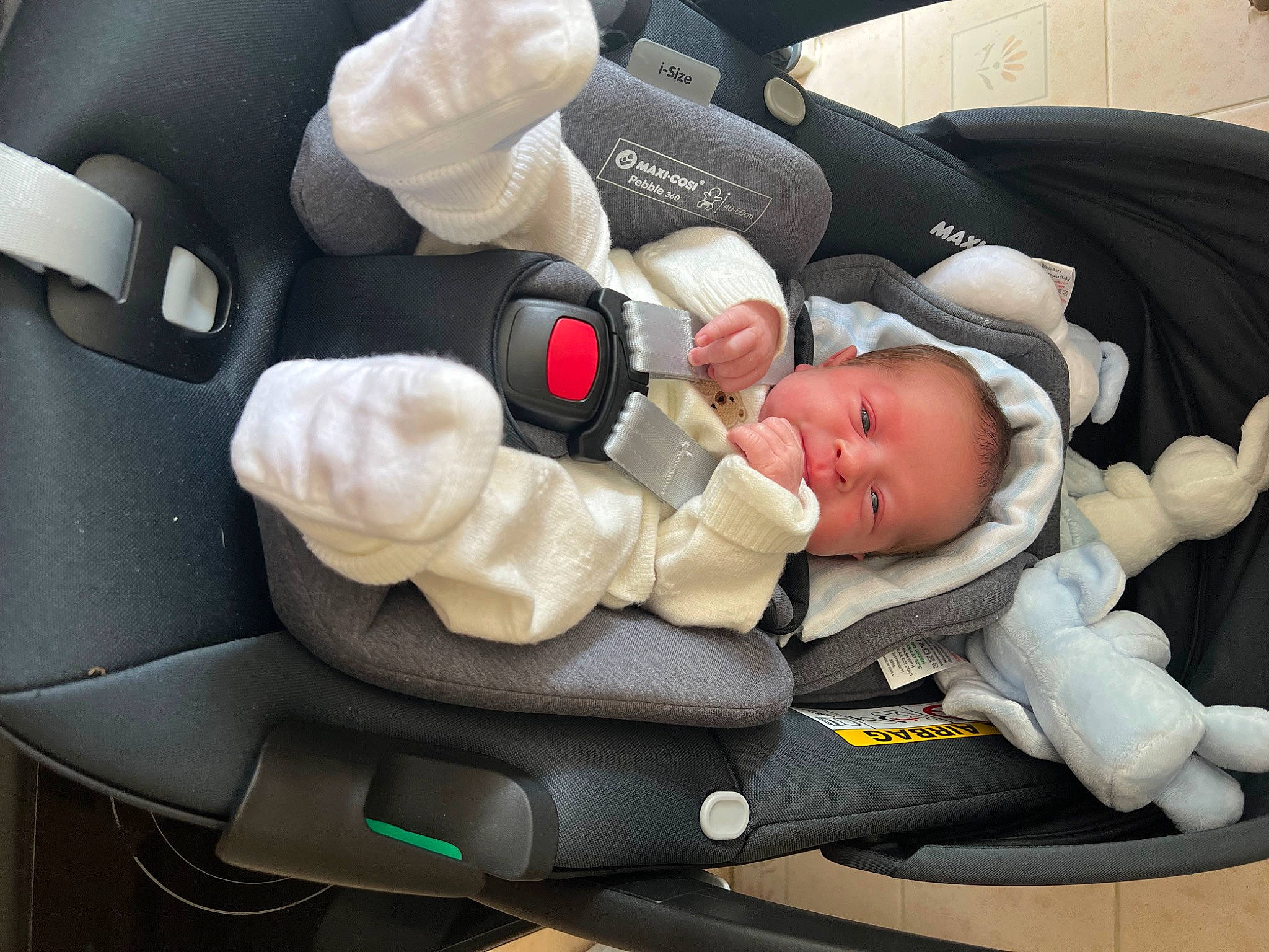 Axton is registered to the contest to win money with this photo: auto_part, automotive_design, baby, baby_carriage, baby_in_car_seat, baby_products, baby_safety, baby_sleeping, baby_toddler_clothing, car_seat, car_seat_cover, carmine, child, comfort, finger, head_restraint, person, seat_belt, service, thumb
