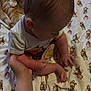 baby, child, infant, hand, blanket, winnie_the_pooh, onesie, person, skin, foot, arm, cuddly, cute, holding_hand, sitting, pattern, soft, indoors, young, support