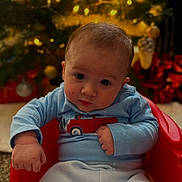 Bryce joined the competition — help win amazing prizes! baby, blue_clothing, child, christmas_tree, cozy, curious, cute, face, festive, holiday_decor, holiday_lights, indoors, infant, portrait, red_chair, sitting, toy_truck_print, warm_lighting, winter_clothes, young_child