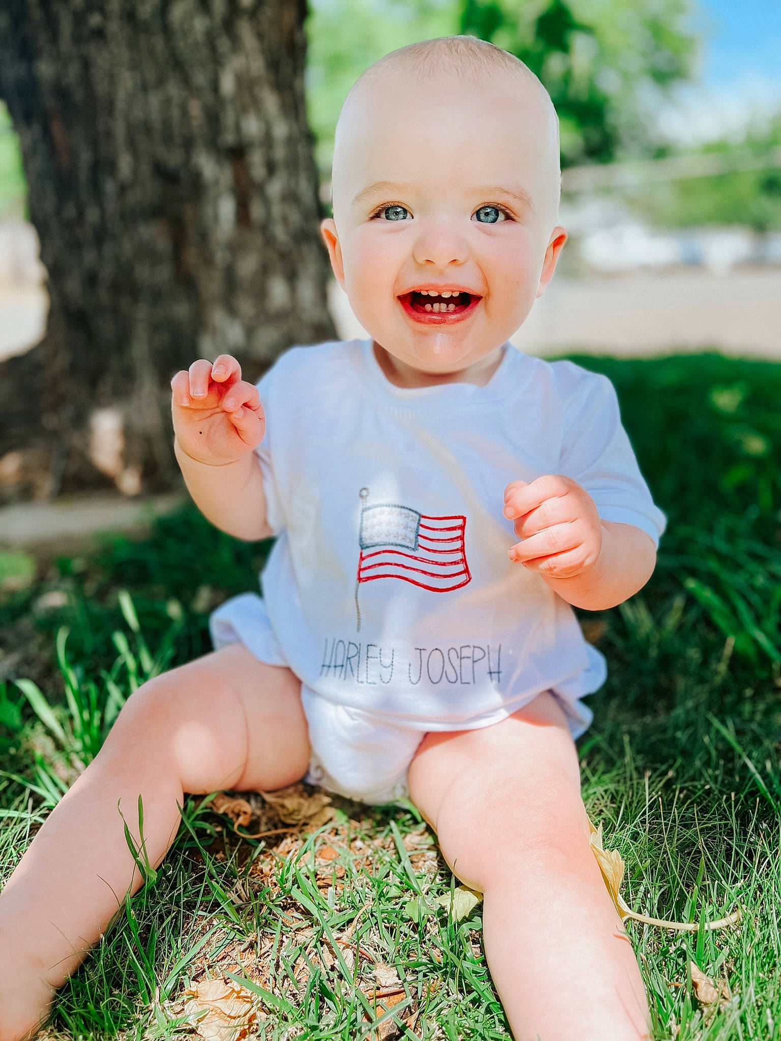 Harley joined the competition — help win amazing prizes! baby, baby_toddler_clothing, eye, face, finger, fun, gesture, grass, hand, happy, head, human_leg, joy, leisure, people_in_nature, person, plant, skin, smile, thigh